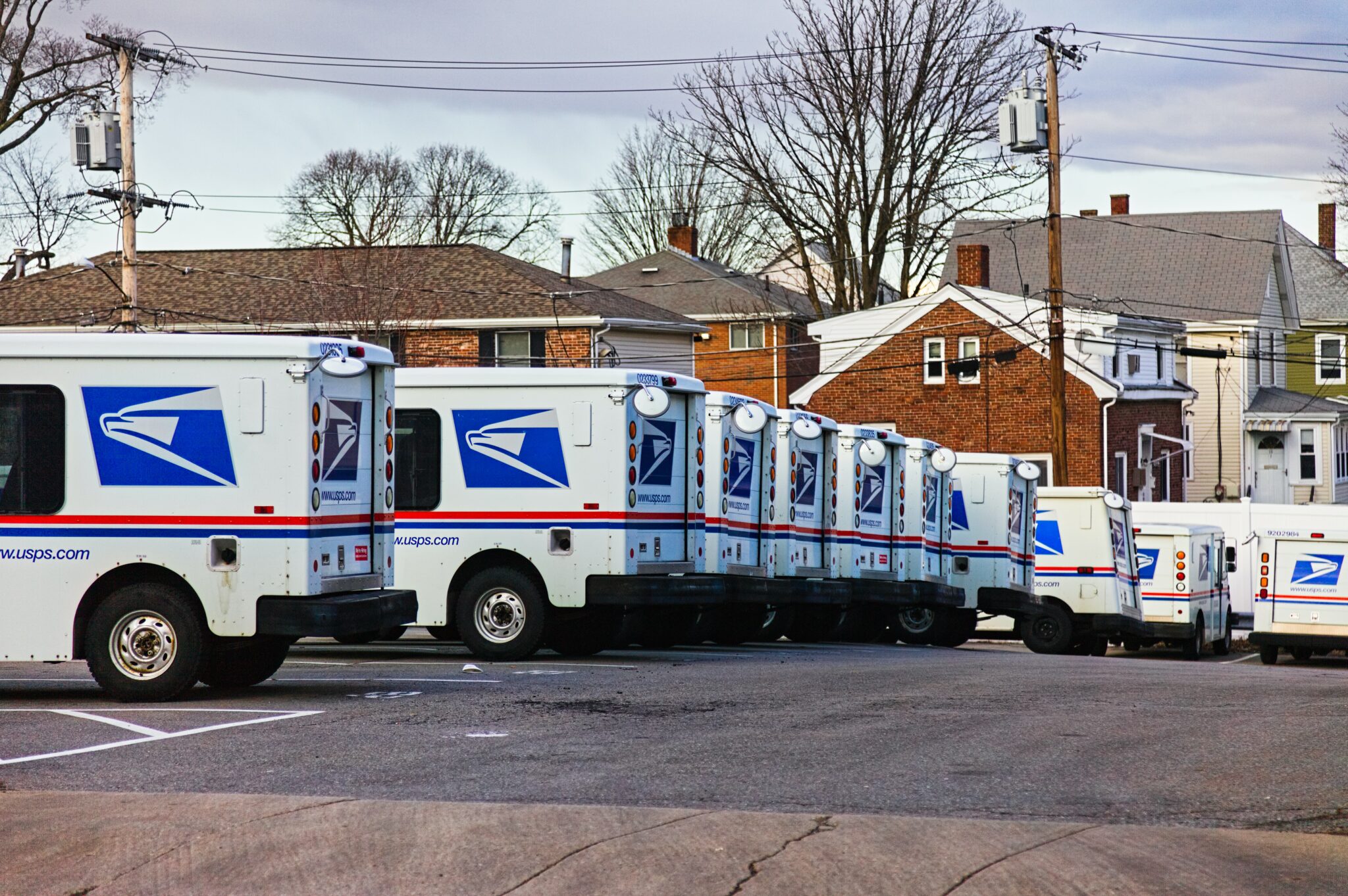 us postal service vans lined up, parked