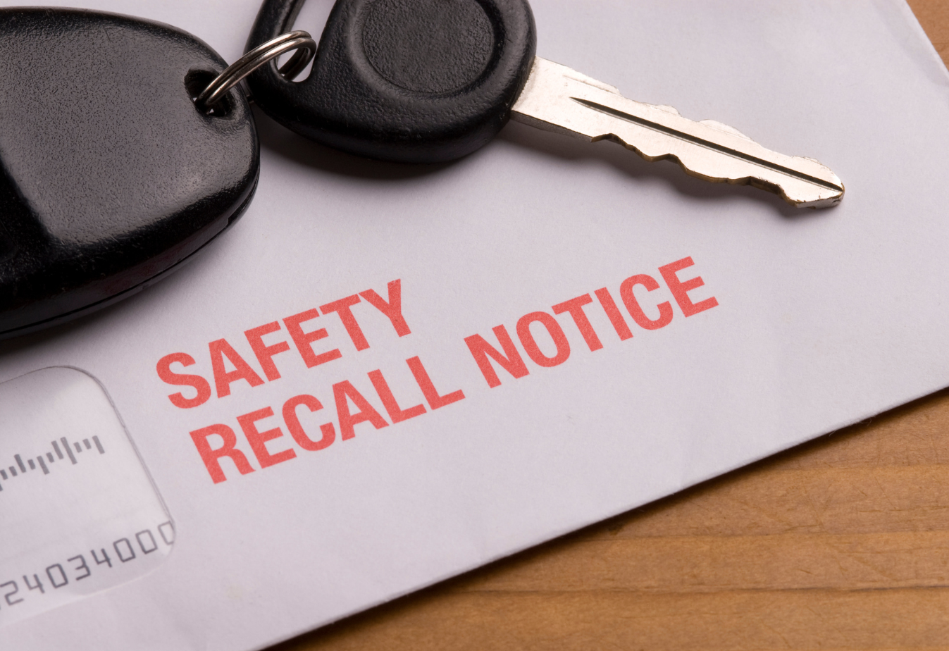 white envelope with car keys on top and red lettering that says safety recall notice
