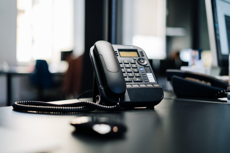 black landline phone on desk